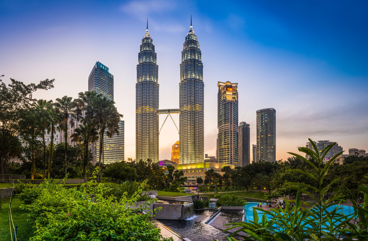 Kuala Lumpur KLCC Park Petronas Towers illuminated at sunset Malaysia